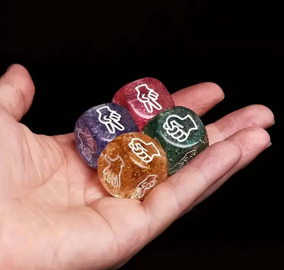 Hand holding five colorful stones with engraved symbols against a black background