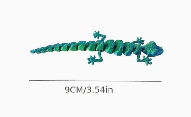 Green toy lizard with size measurement on a white background
