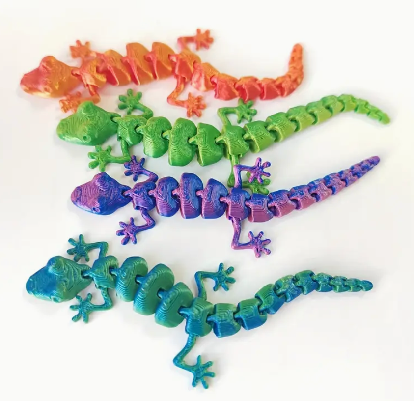 Colorful plastic lizard toys on a white background