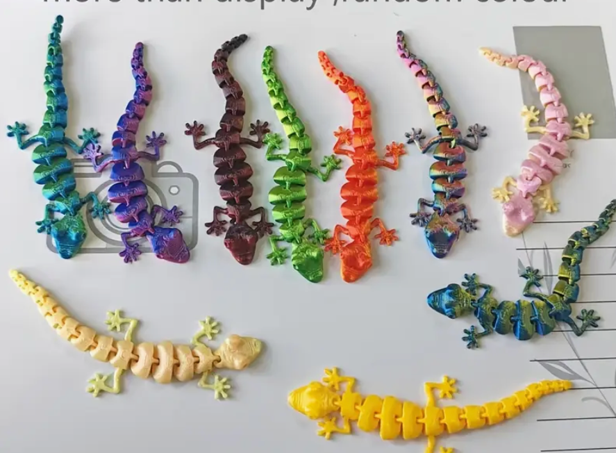 Colorful toy lizards on a white surface with a grid pattern