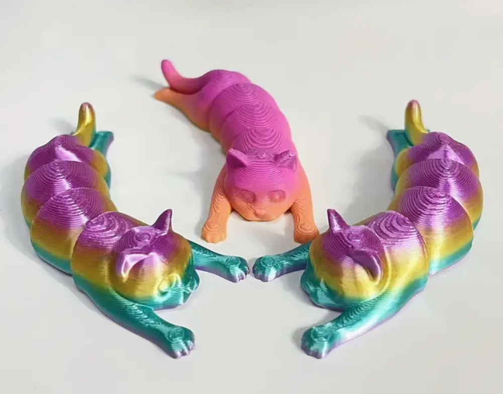 A 3.5" 3D-printed cat figurine in pastel tie-dye colors, featuring a smooth finish and charming design.