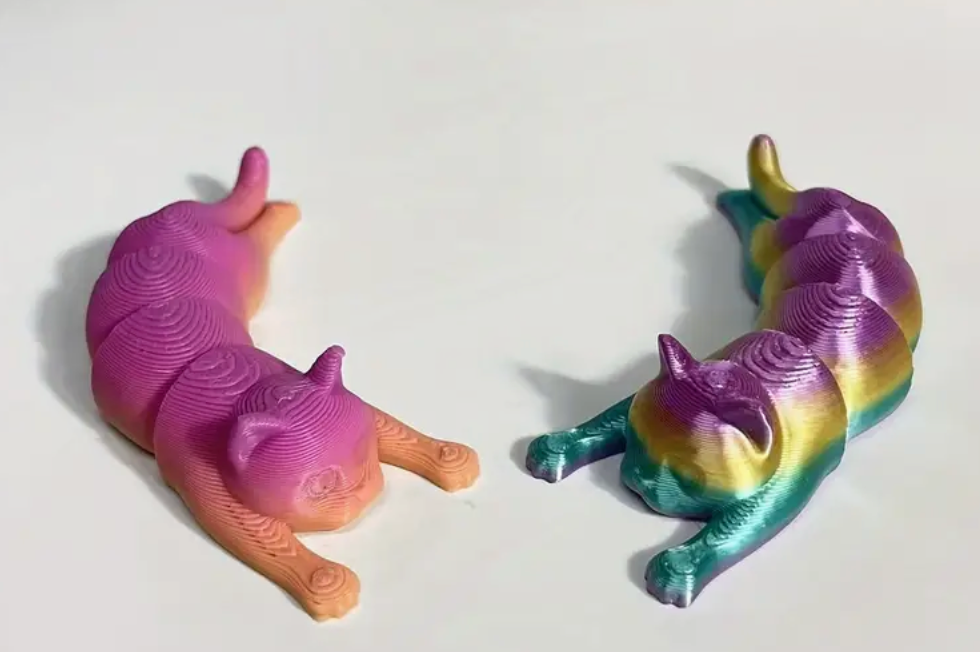 A 3.5" 3D-printed cat figurine in pastel tie-dye colors, featuring a smooth finish and charming design.
