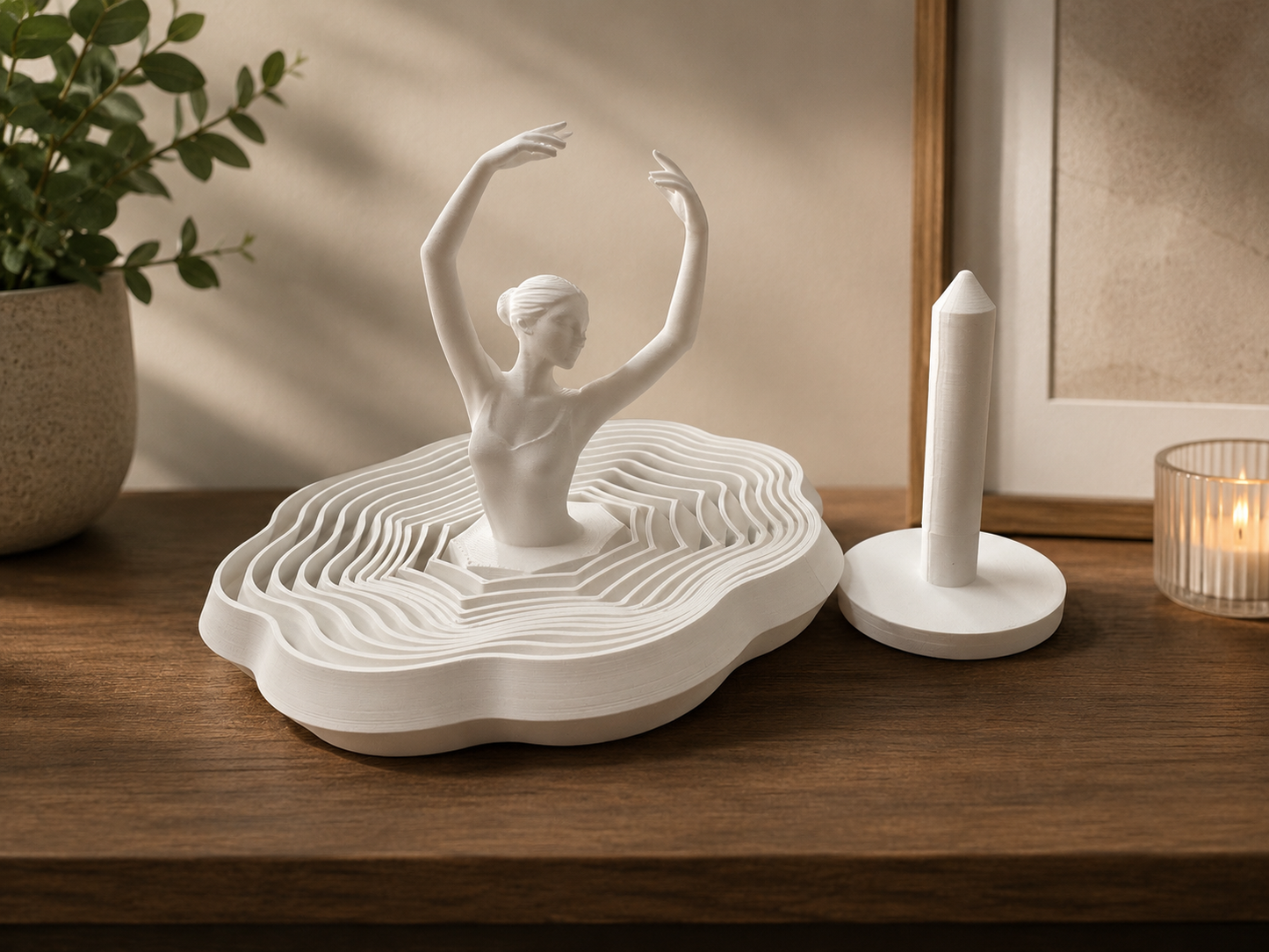 White 3D print of a dancer on a wavy base with a candle in the background.