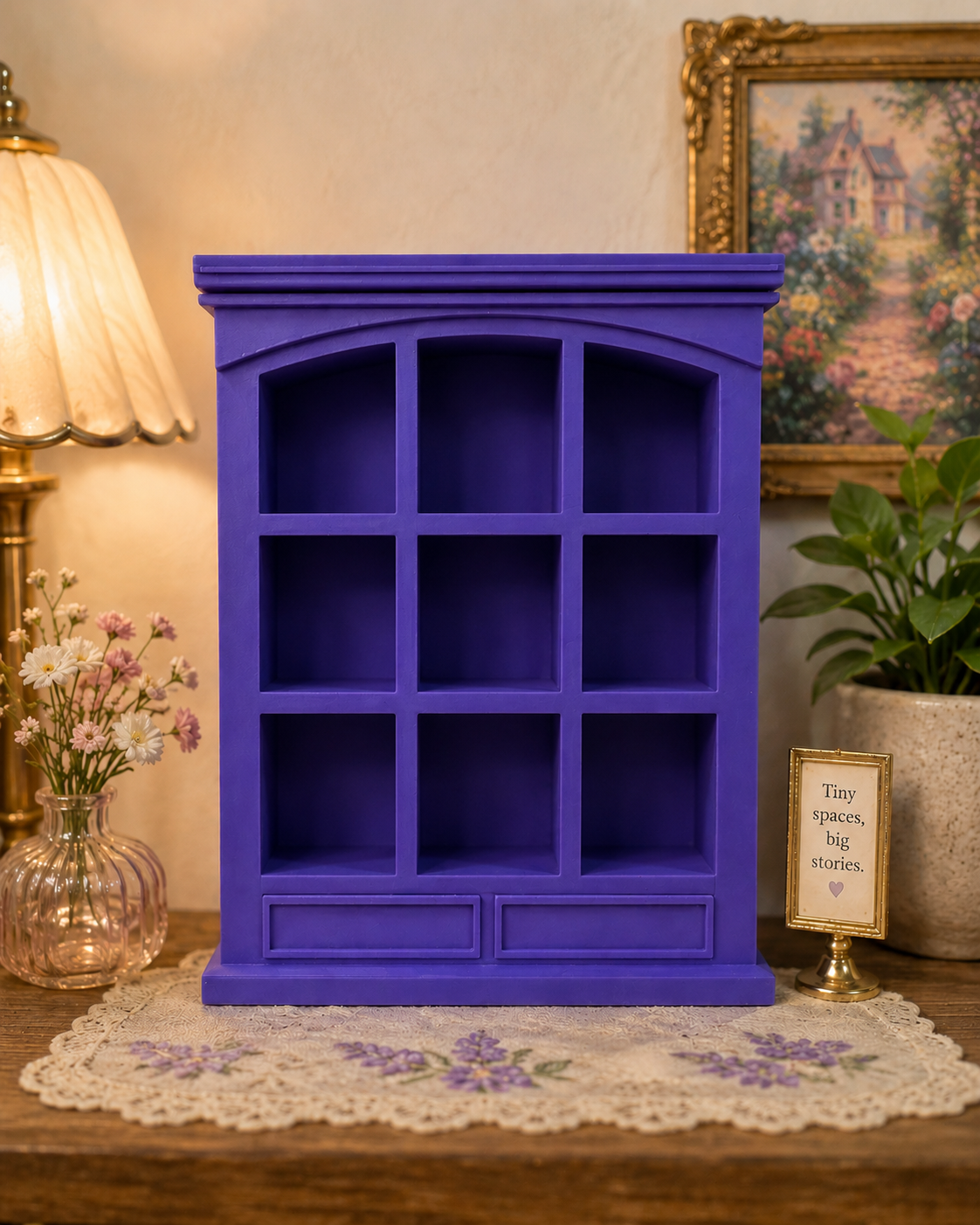 Purple bookshelf on a wooden table with decorative items in the background