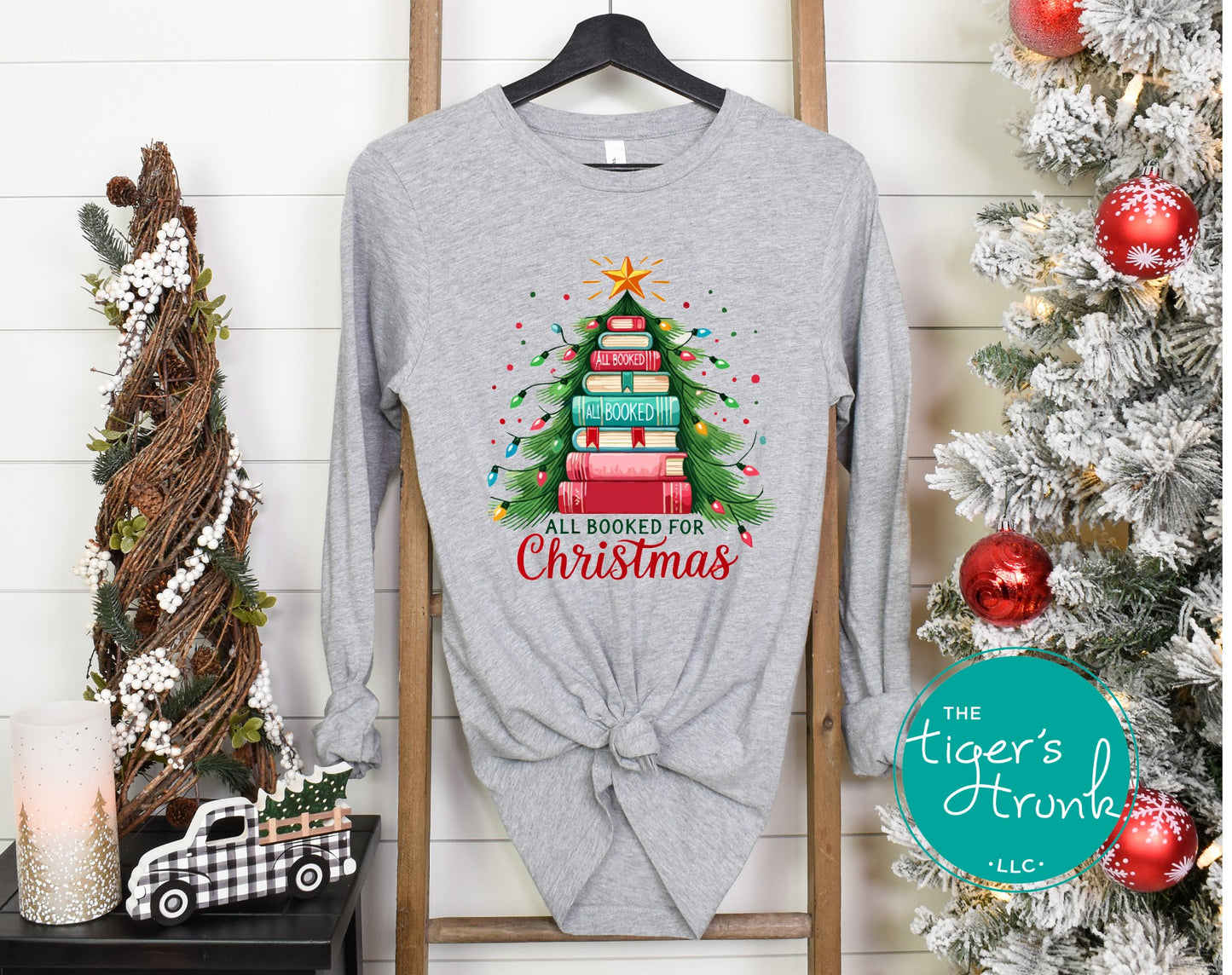 Adult long sleeve Christmas shirt with the phrase All Booked for Christmas and an image of a Christmas tree made of books