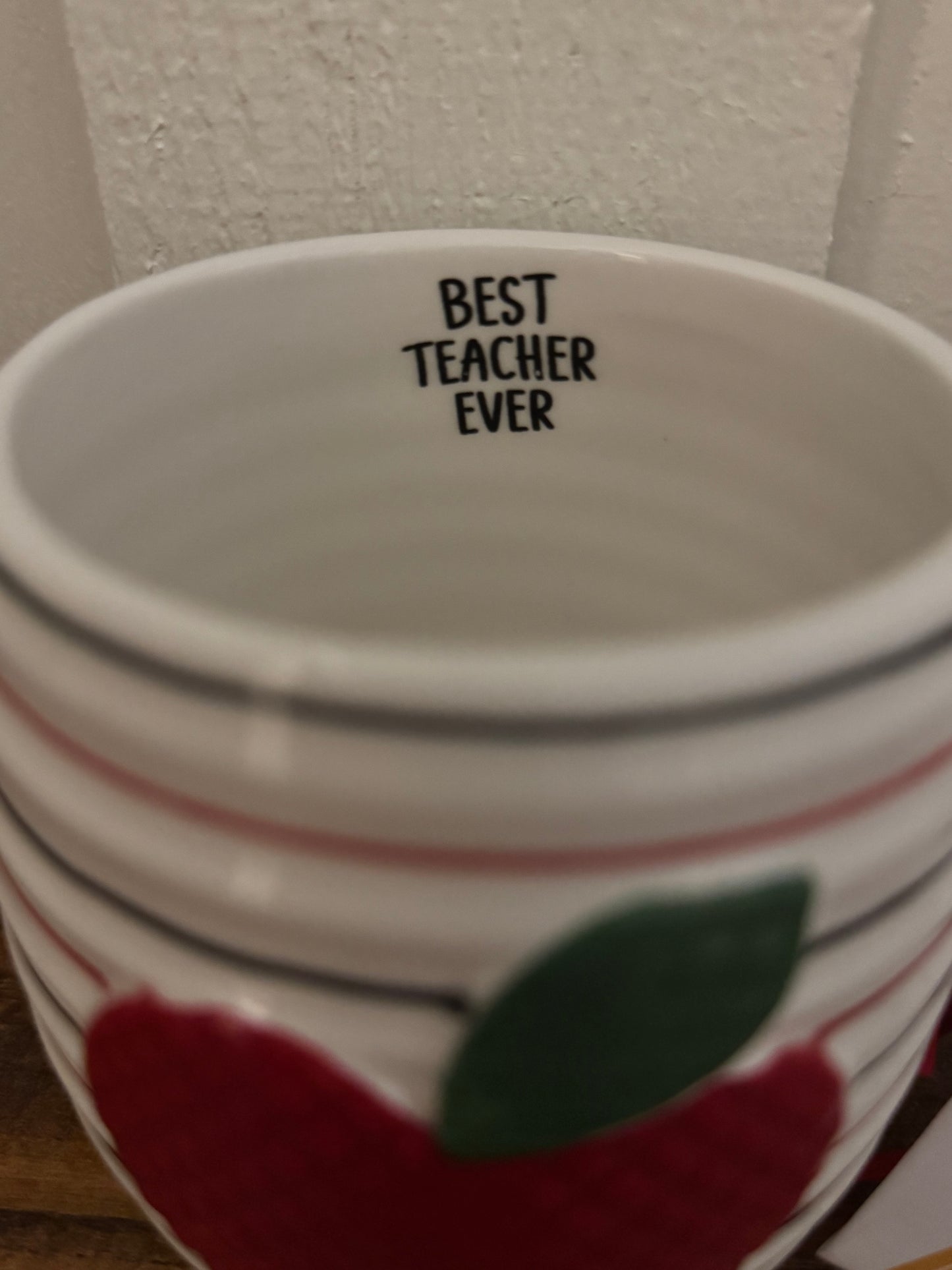 Ceramic mug with 'Best Teacher Ever' text and apple design on a white background