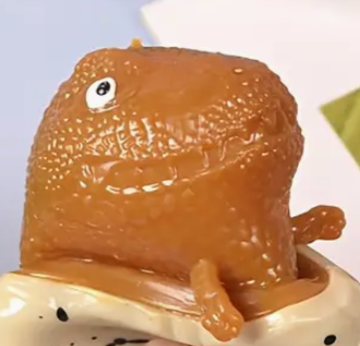 Brown ceramic snail on a white base with black dots