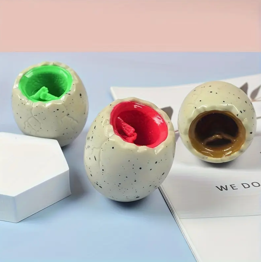 Three ceramic apple-shaped bowls with different colored interiors on a light blue surface.