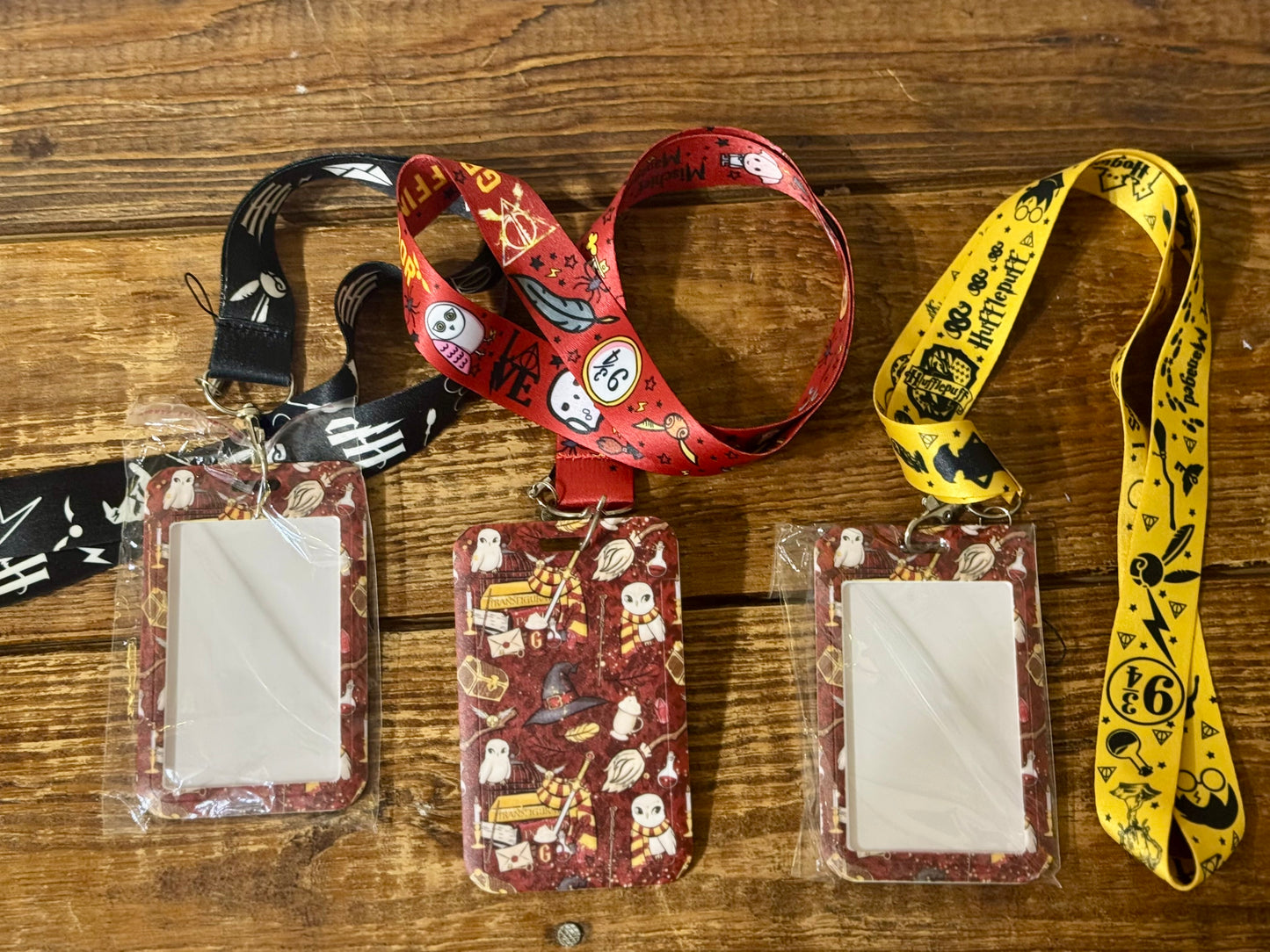Harry Potter-themed lanyard with attached decorated hard ID case, featuring iconic symbols from the wizarding world.