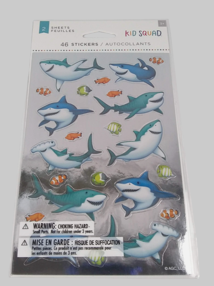Pack of shark stickers with warning label on a gray background