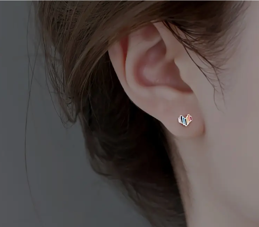 Pair of small rainbow heart-shaped stud earrings made from lightweight alloy