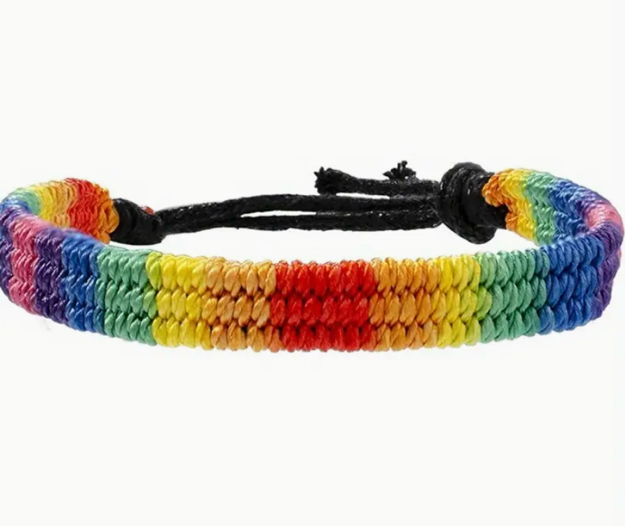 Woven rainbow polyester bracelet with adjustable ends, representing LGBTQ+ Pride