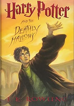 Front cover of Harry Potter and the Deathly Hallows by J.K. Rowling, featuring Harry reaching for a glowing light under a stormy sky.
