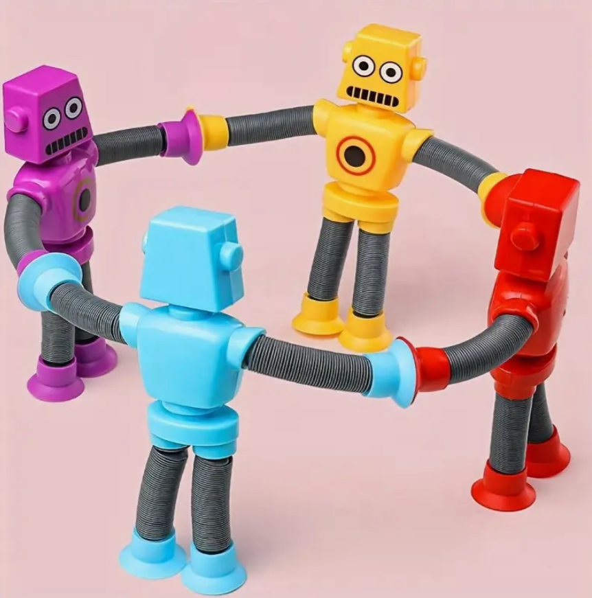 Four colorful robot toys connected by flexible arms on a pink background