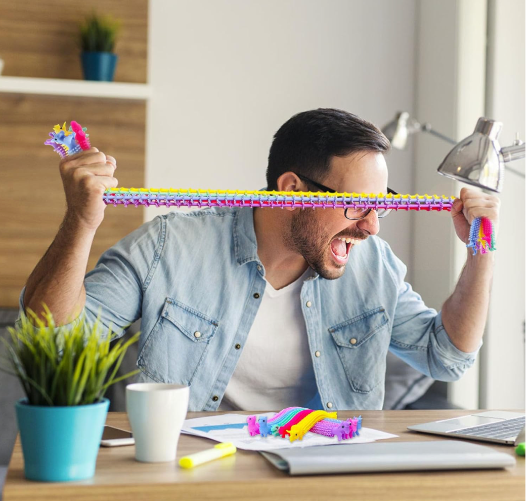 Colorful alpaca-shaped stretchy fidget toys in assorted colors and textures, shown coiled and stretched