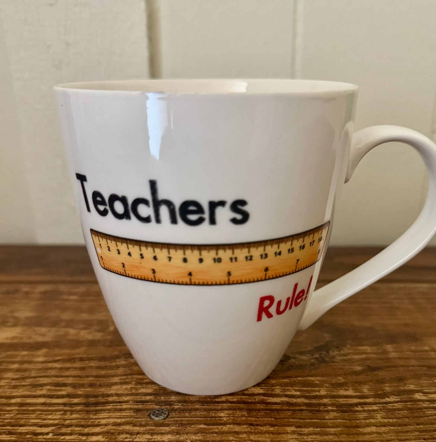White ceramic mug with the phrase Teachers Rule and a printed ruler graphic