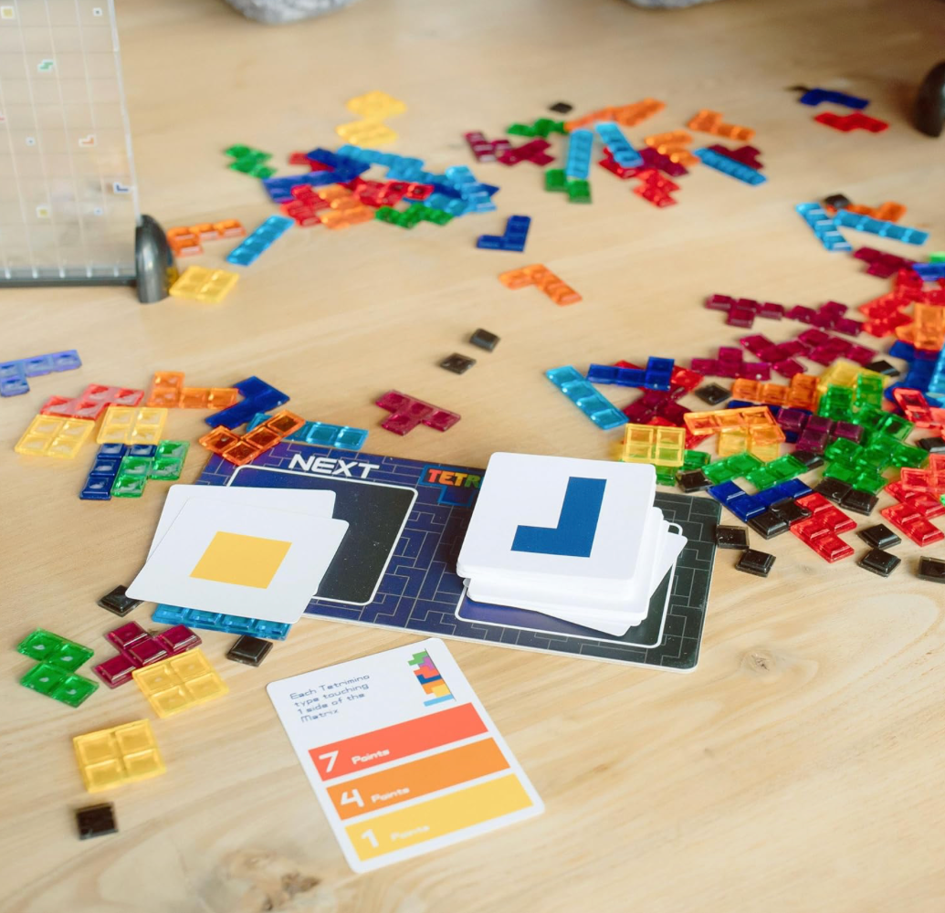Colorful building blocks and game cards on a wooden surface