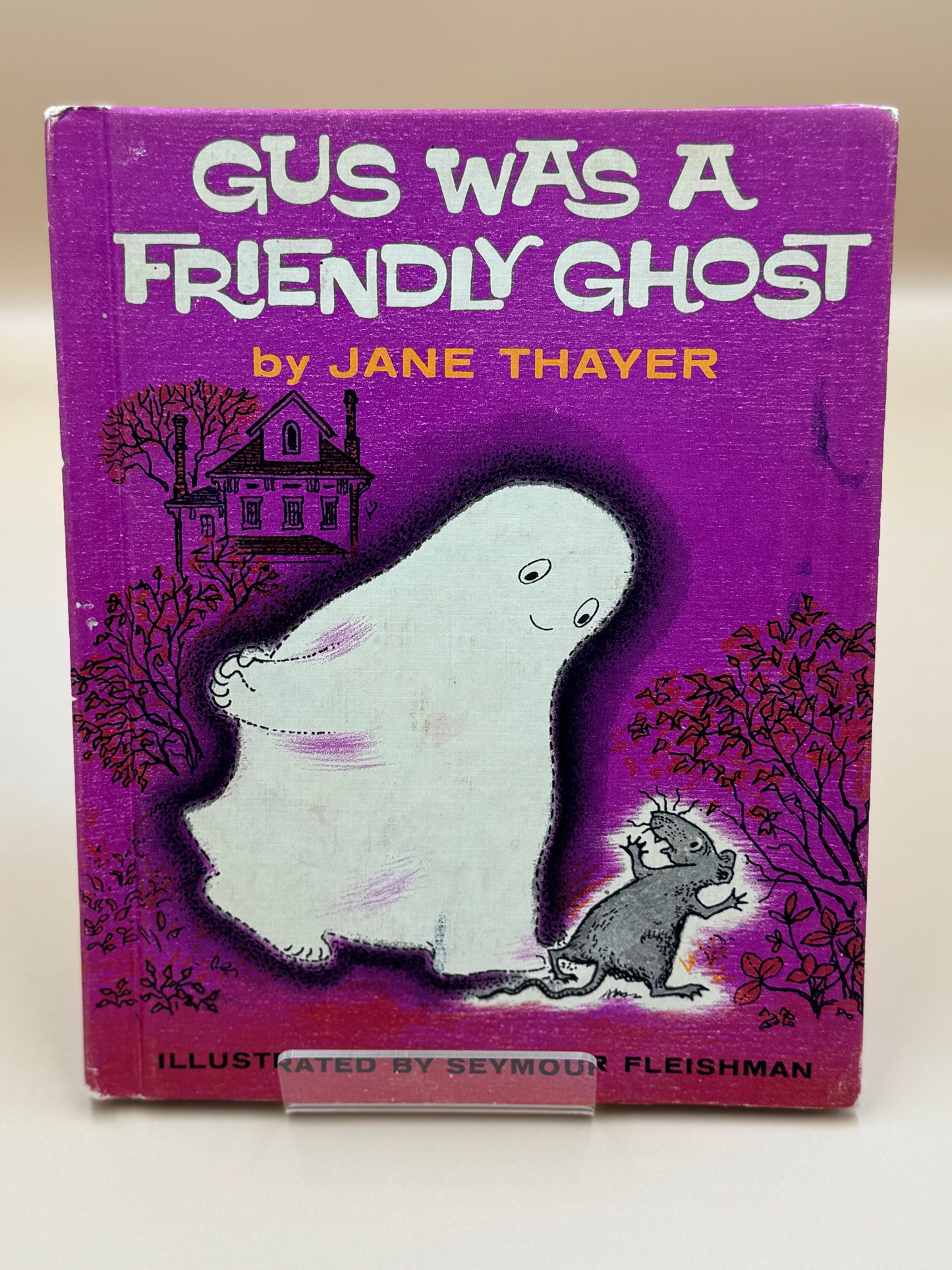Book cover of 'Gus Was a Friendly Ghost' by Jane Thayer with a ghost and mouse illustration on a purple background.