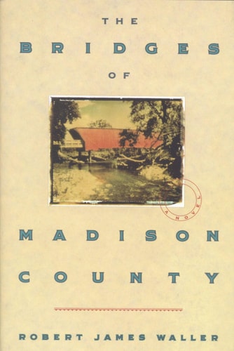 Cover of The Bridges of Madison County by Robert James Waller, featuring a serene rural landscape with a covered bridge, symbolizing the novel's romantic setting.