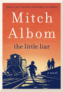 Cover of The Little Liar by Mitch Albom, depicting an 11-year-old boy, Nico Krispis, standing on a train platform during World War II, with a somber atmosphere reflecting the novel's themes.