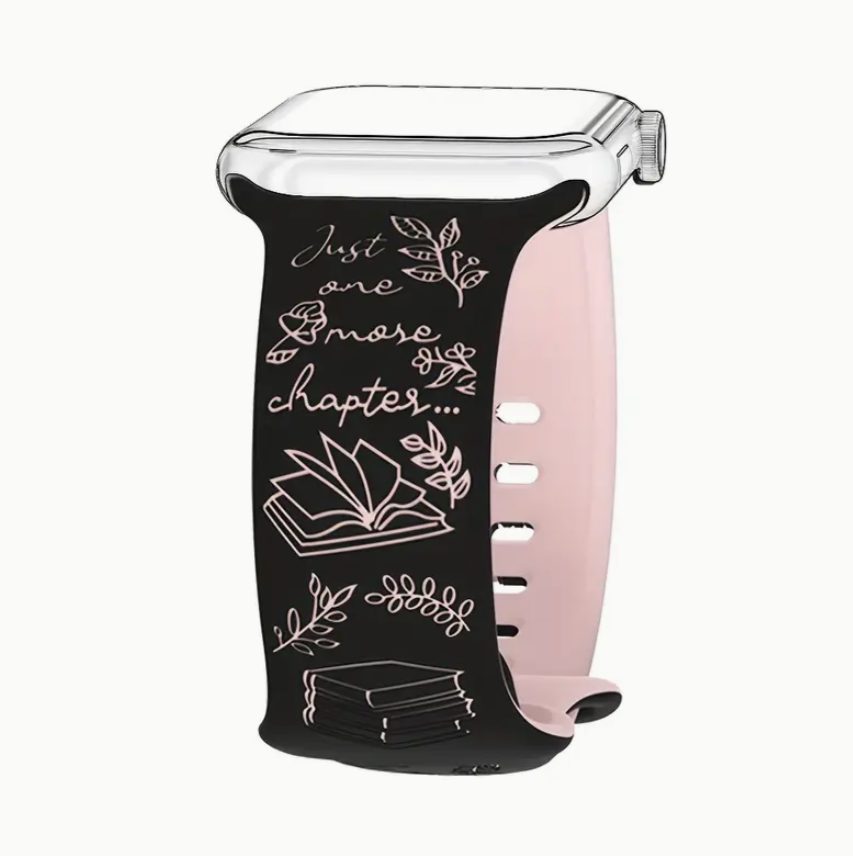 Smartwatch with a black band featuring white text and designs on a white background