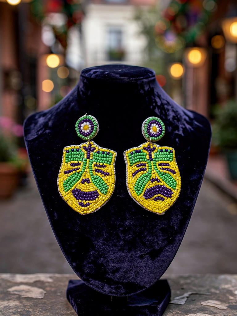 Beaded Mardi Gras mask earrings in purple green and gold displayed on a velvet jewelry stand