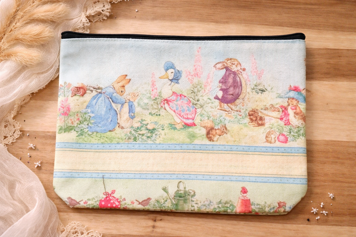 Beatrix Potter inspired zipper pouch with Peter Rabbit style garden animal illustration on fabric bag