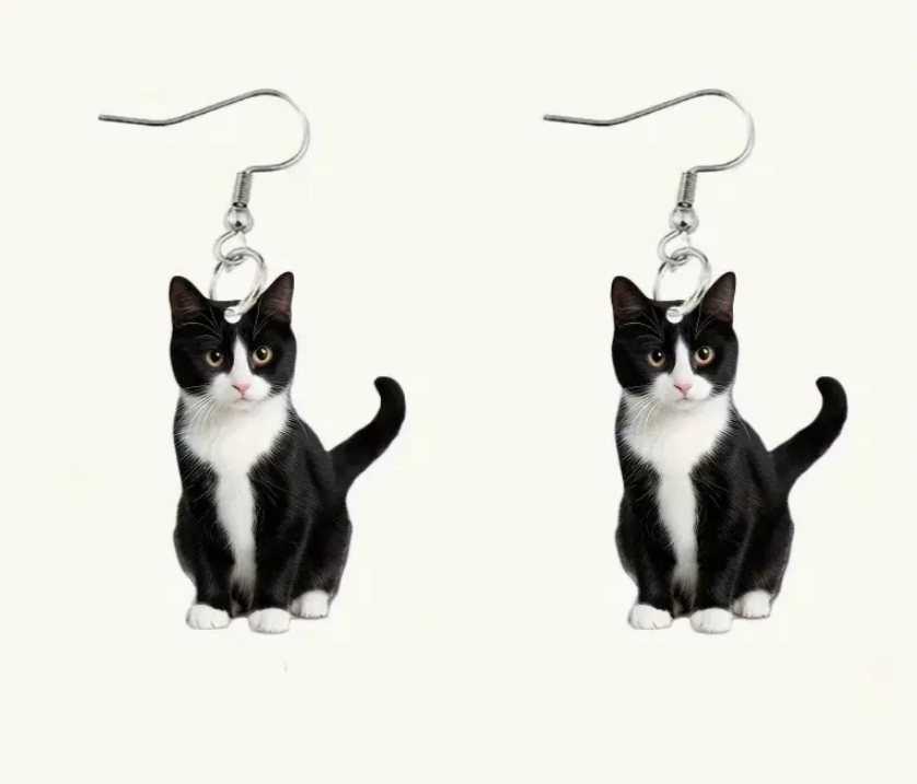 Cat-shaped earrings on a white background
