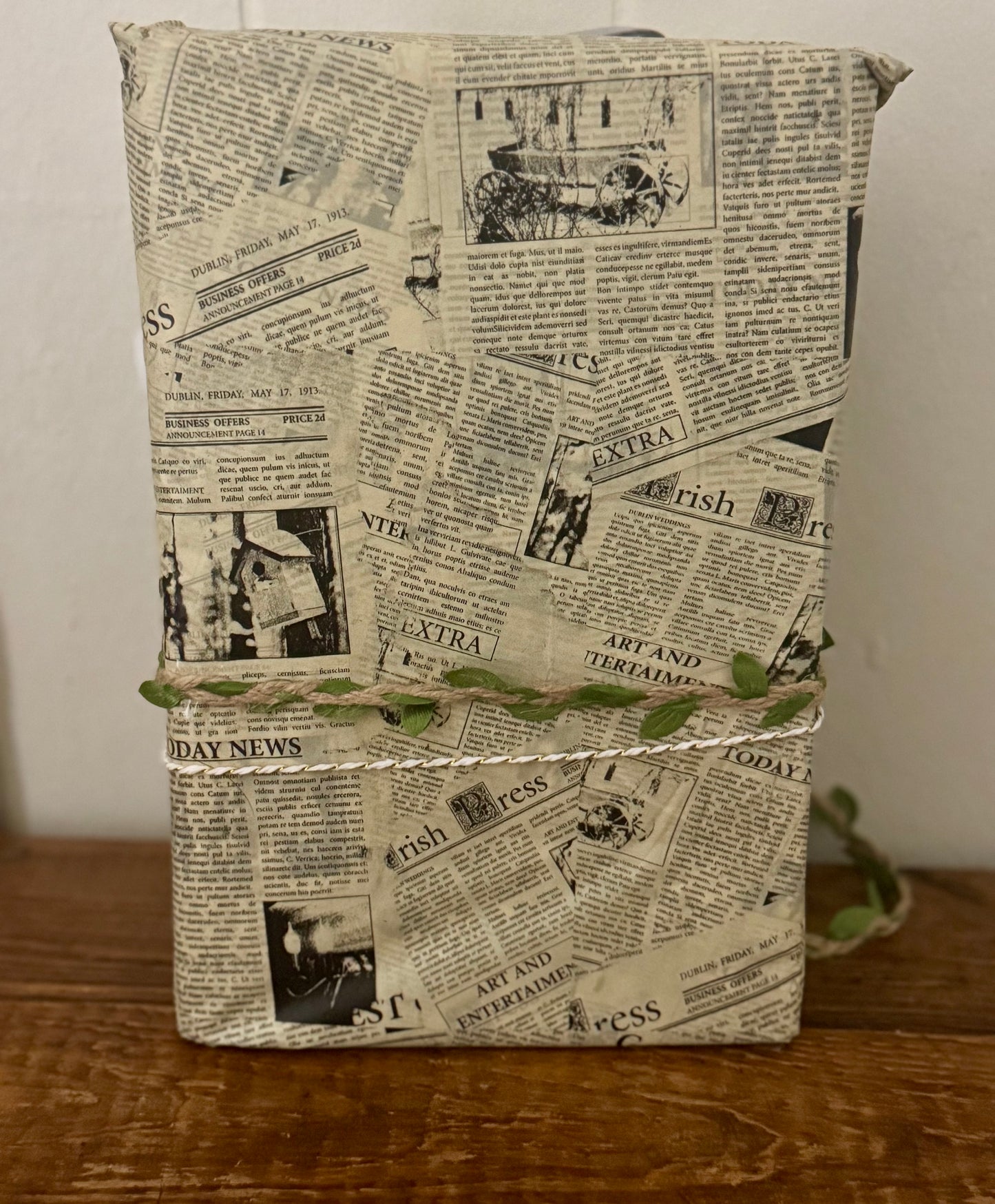 Book or notebook with newspaper print cover on a wooden surface