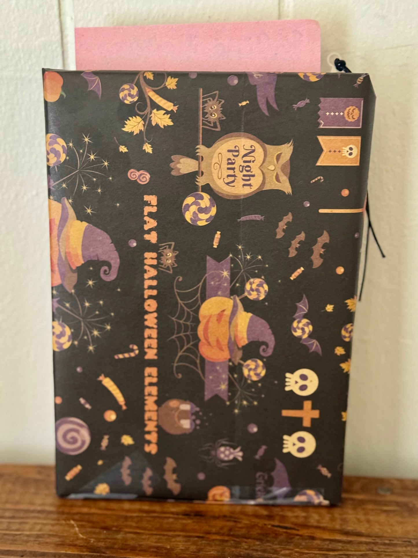 Halloween-themed pouch with decorative patterns on a wooden surface