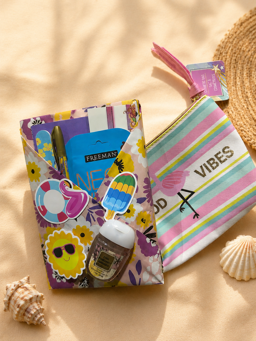 Beach-themed Blind Date with a Book package wrapped in floral paper with colorful summer stickers, bookish accessories, hand sanitizer, and a striped pouch that says Good Vibes