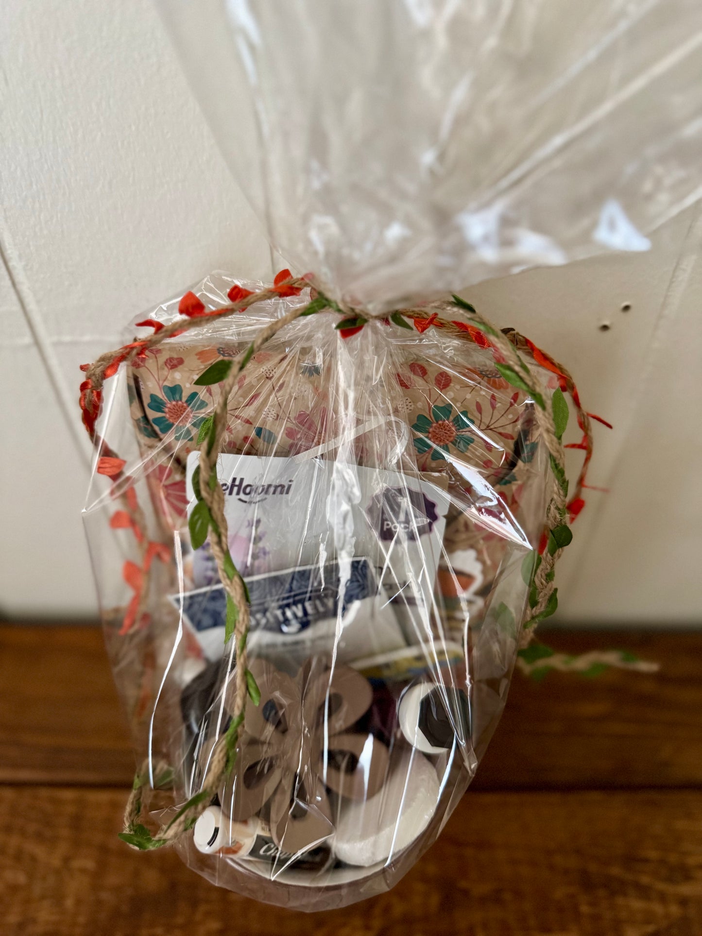 Heart-shaped bag with decorative elements and a visible brand label on a white ceiling background.