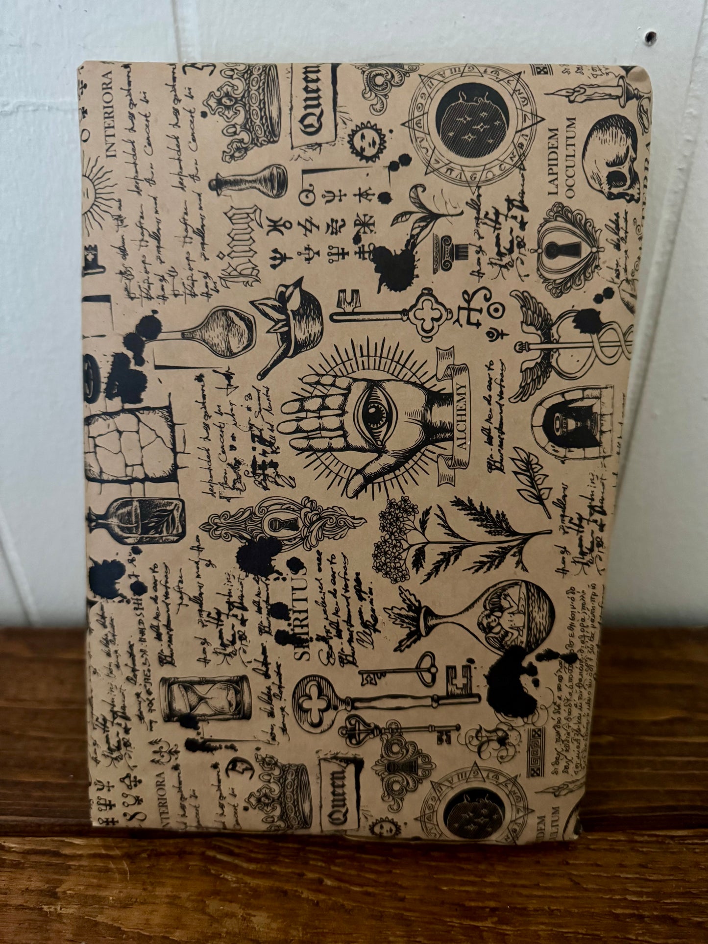 Notebook with vintage-style design on a wooden surface