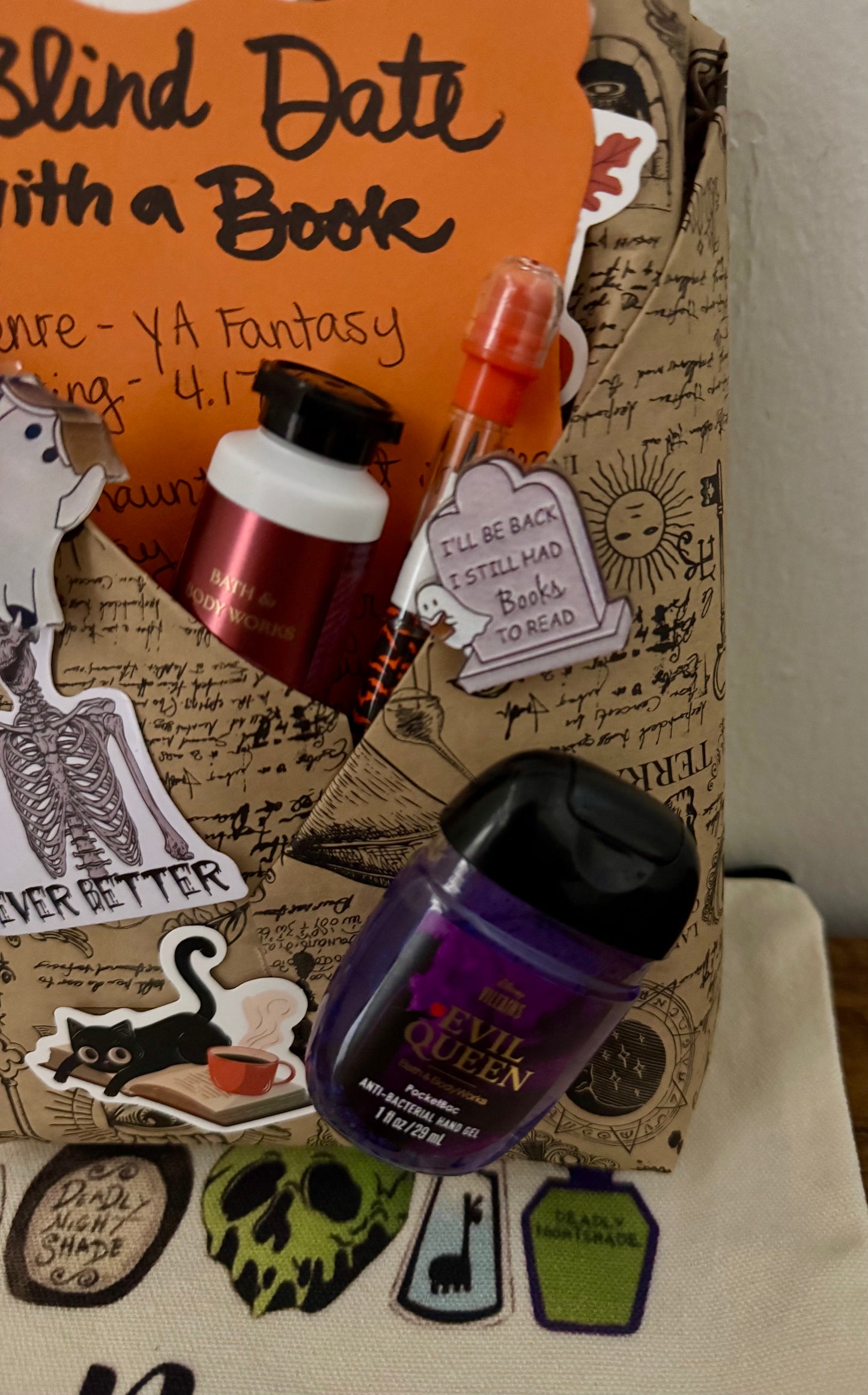 Decorative book with miniature bottles and stickers on a plain background
