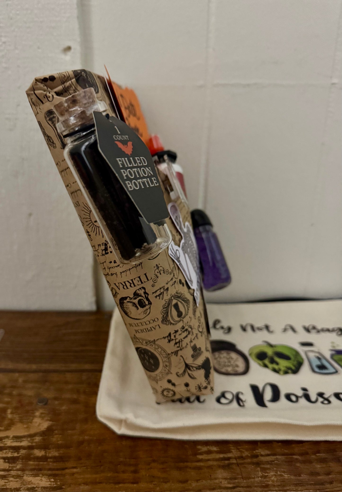 Decorative potion bottle with packaging on a wooden surface