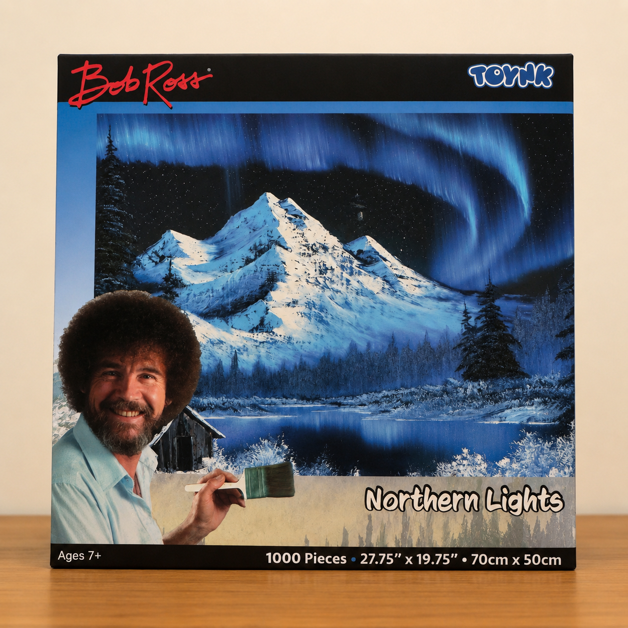 Bob Ross Northern Lights 1000-piece jigsaw puzzle featuring a colorful nighttime landscape scene with glowing northern lights and peaceful nature artwork