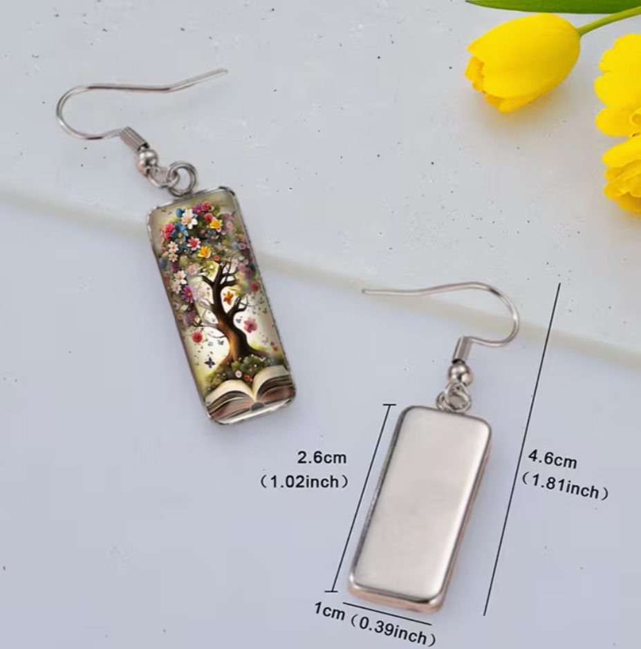 Pair of earrings with floral design on a white background with measurements.