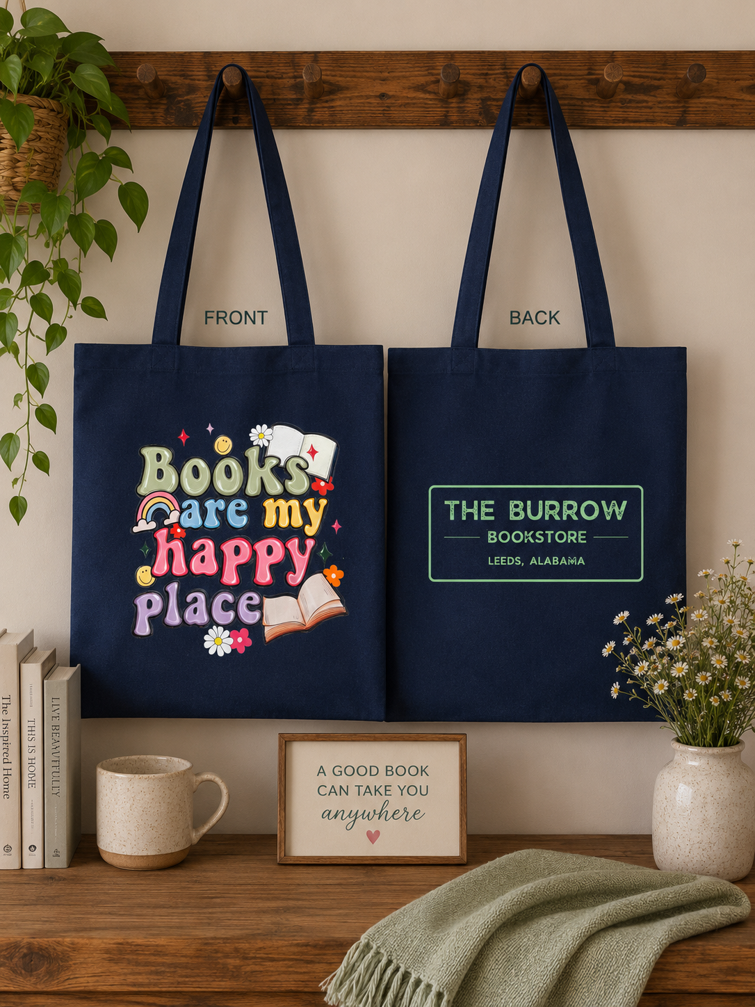 Navy blue two-sided canvas tote featuring a colorful Books Are My Happy Place design on the front and The Burrow Bookstore logo on the back.