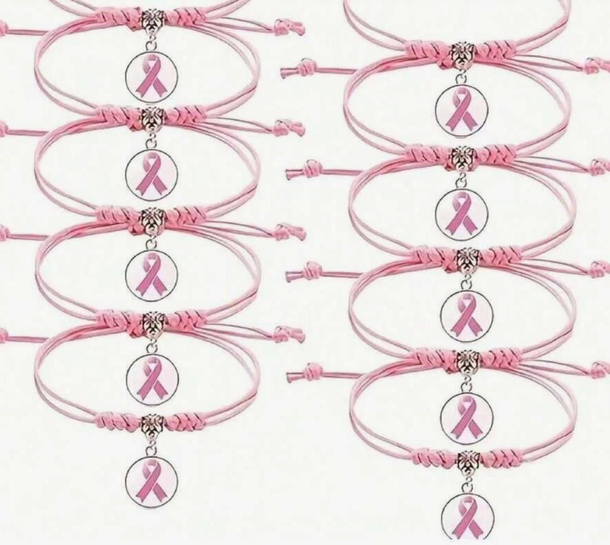 Pink bracelets with breast cancer awareness ribbons on a white background