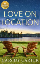 Cover of Love on Location by Cassidy Carter, featuring a picturesque lakeside setting with two Adirondack chairs facing the water, capturing the novel's romantic and serene atmosphere.