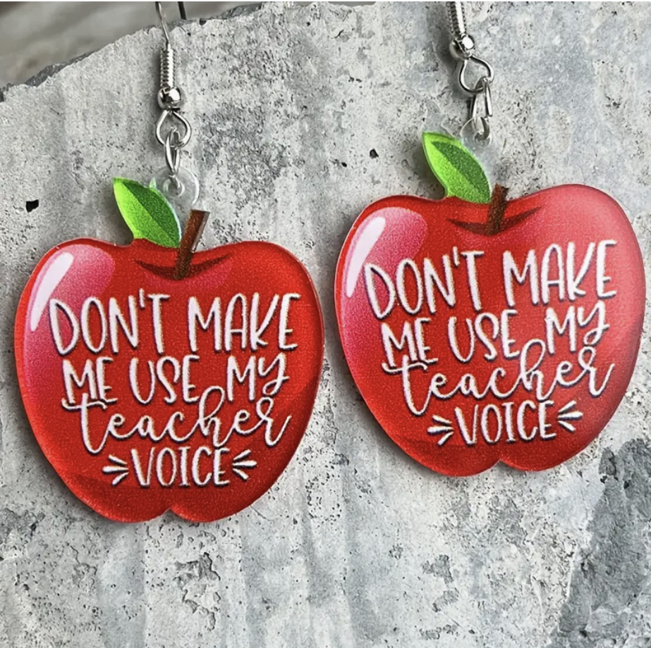 Pair of red acrylic apple-shaped earrings featuring the phrase Don’t Make Me Use My Teacher Voice, perfect for educators with a sense of humor.