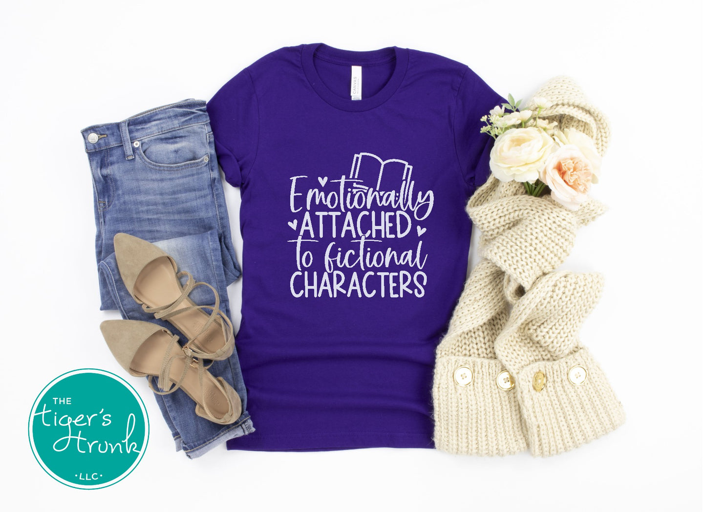 Purple t-shirt with text, jeans, shoes, and a scarf on a white background
