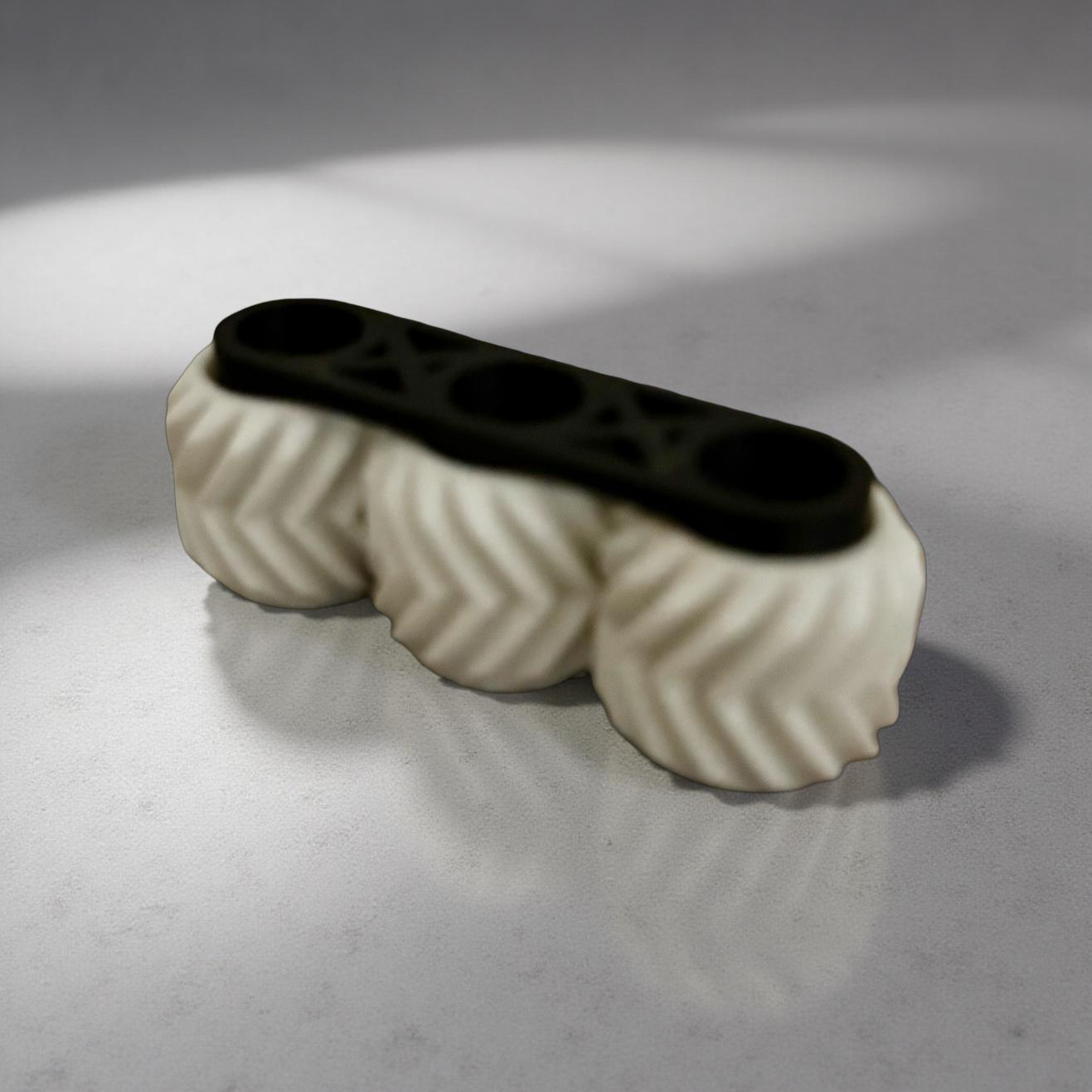 Black-and-white spinning wheel fidget toy shown on a white base, approximately 2.5 inches long