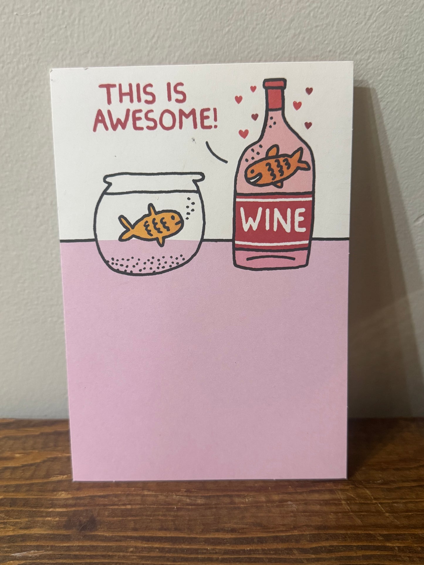 A humorous Valentine’s Day card featuring a goldfish in a bowl and another in a bottle of wine, with the fish in the wine saying, This is awesome!