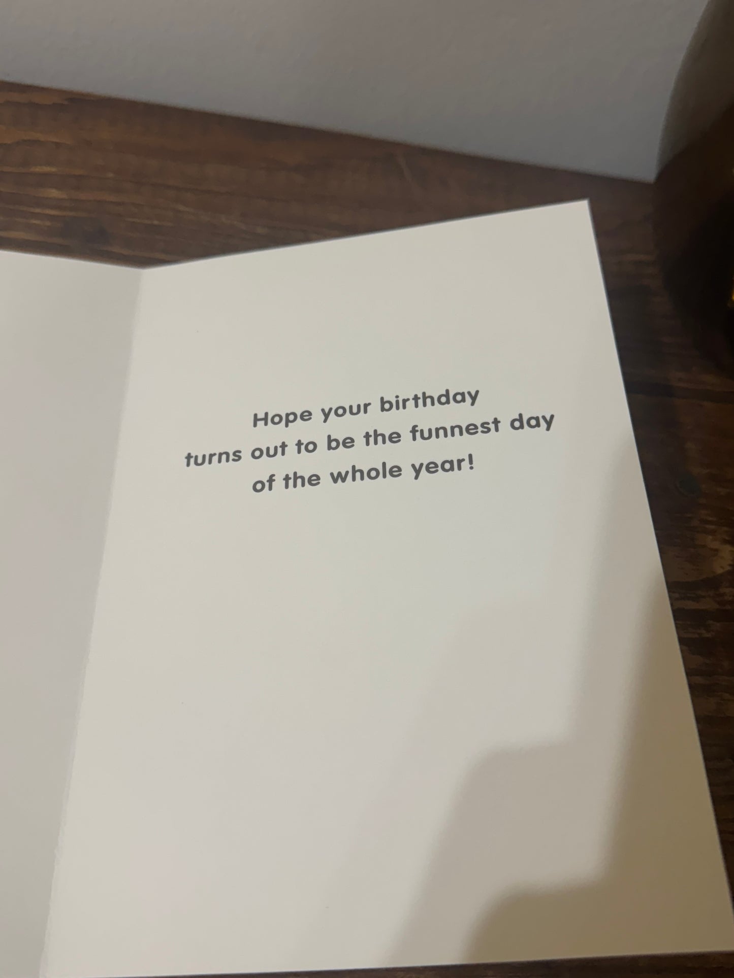 A playful birthday card featuring a unicycling panda with glitter accents and the word Fun on the front.