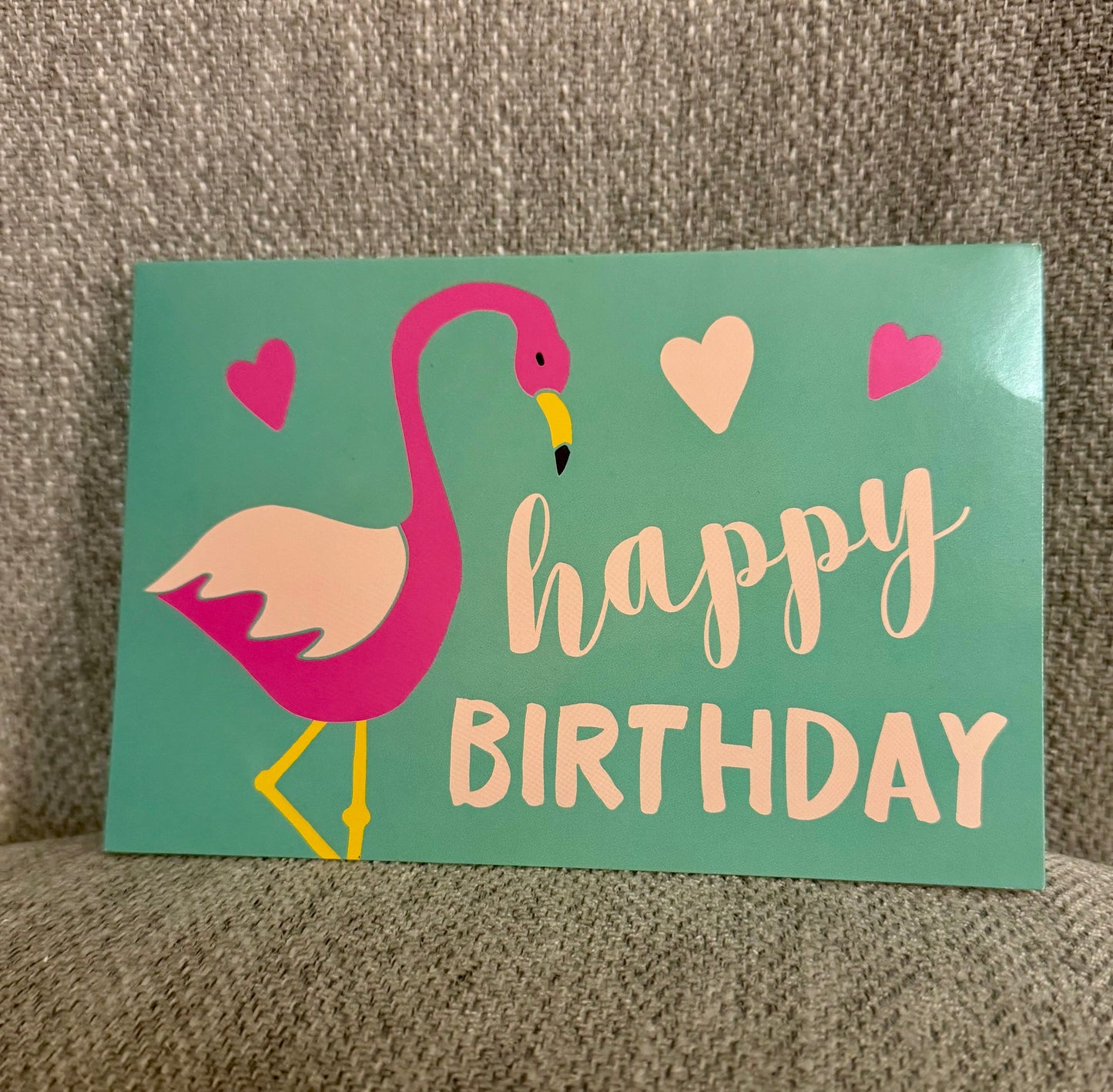 A vibrant Happy Birthday card featuring a playful flamingo illustration, perfect for celebrating any special day.