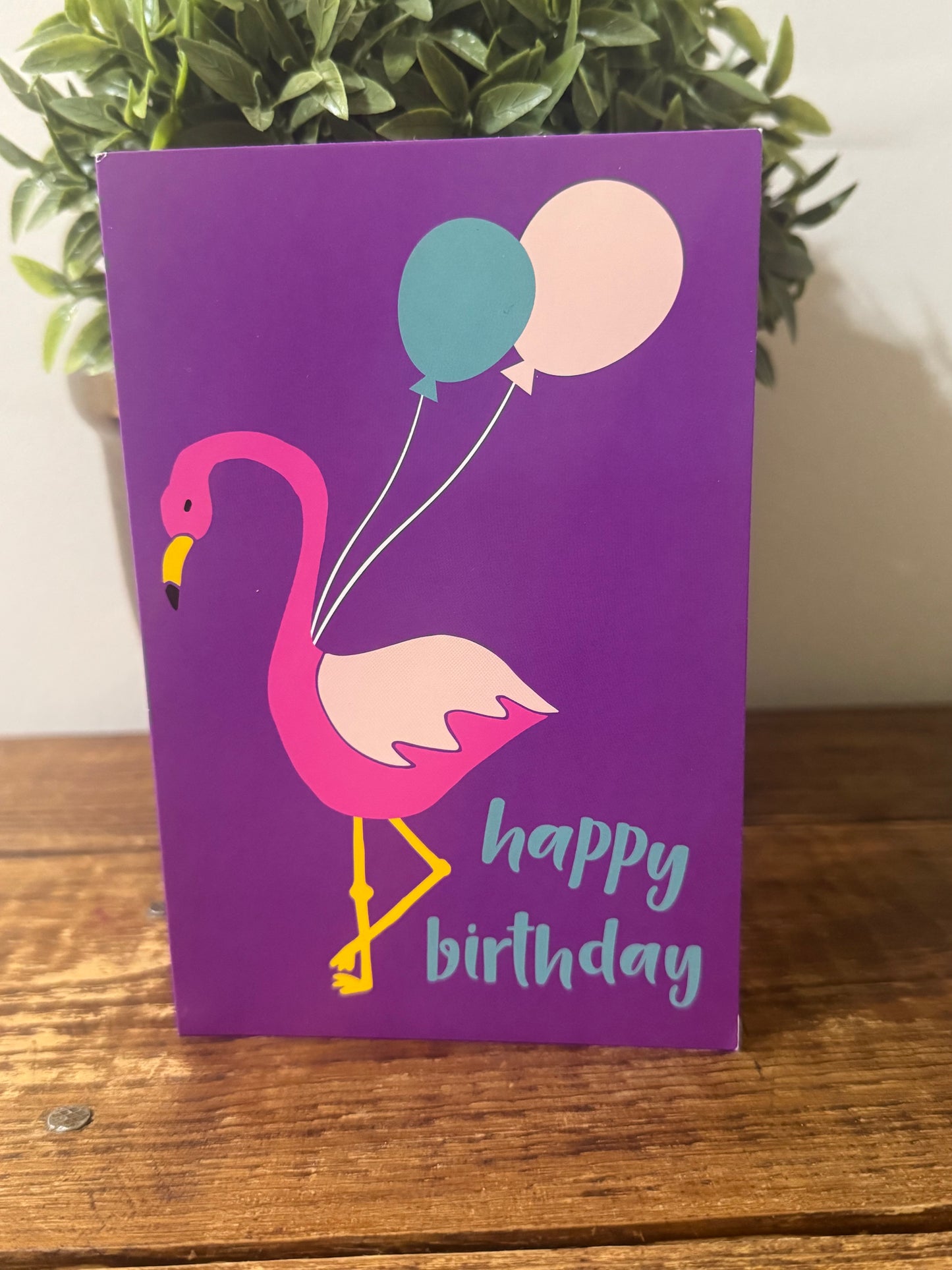 A vibrant Happy Birthday card featuring a playful flamingo illustration, perfect for celebrating any special day.