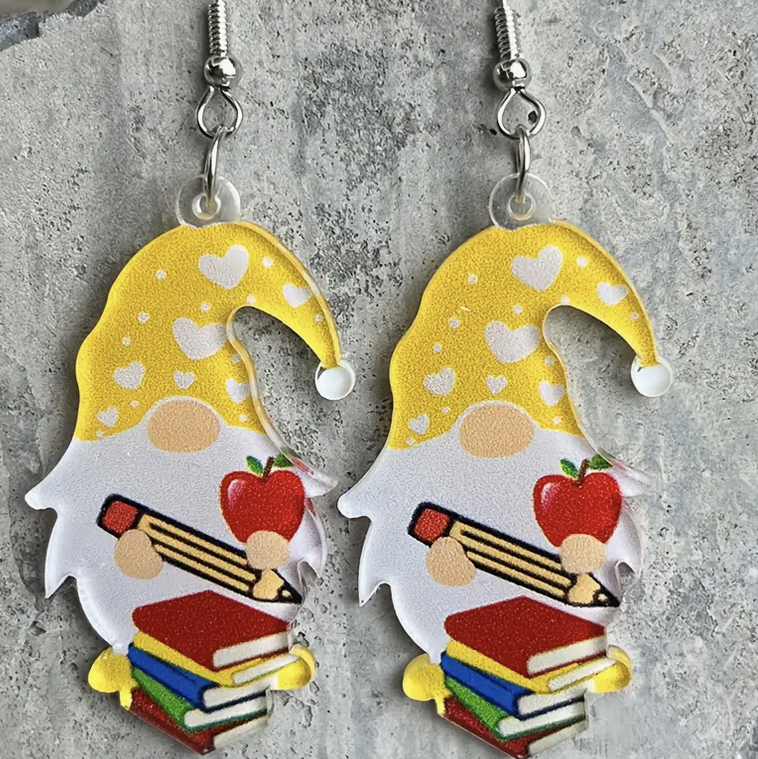 Pair of acrylic earrings featuring cheerful gnomes carrying textbooks, pencils, and apples—perfect for teachers and school-themed outfits.