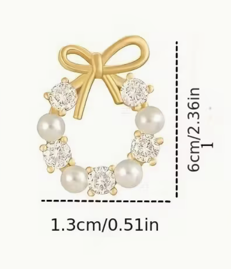 Golden-tone bow and pearl wreath earring shown with measurement guide indicating size in centimeters and inches.