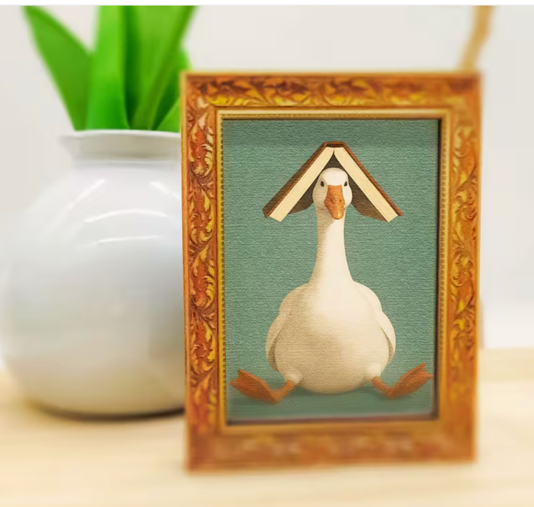 Wooden refrigerator magnet featuring a white goose sitting with an open book balanced on its head inside a decorative vintage-style frame.